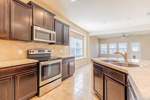 kitchen with tasteful backsplash, sink, plenty of natural light, and appliances with stainless steel finishes