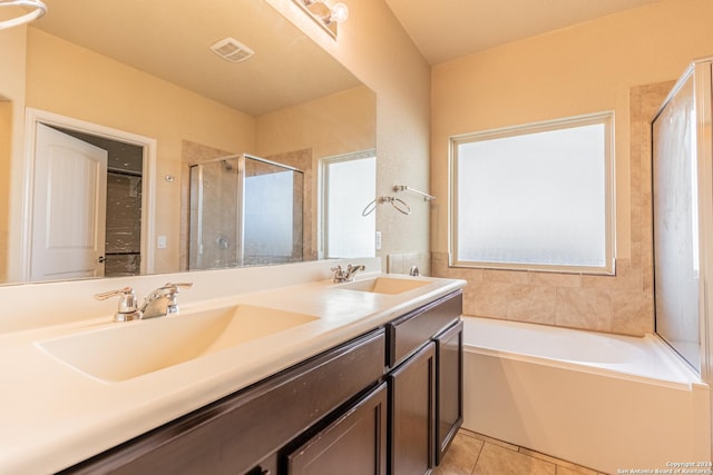 bathroom featuring tile patterned flooring, vanity, and shower with separate bathtub