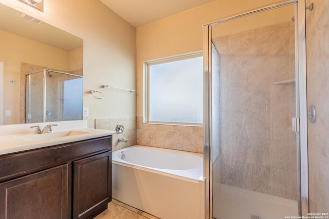 bathroom with plus walk in shower, vanity, and tile patterned floors