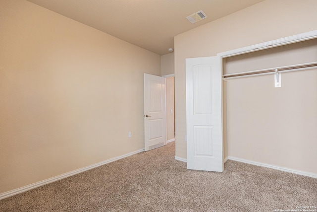 unfurnished bedroom with carpet and a closet