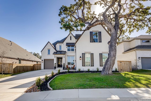 view of front of property featuring a front yard and a garage