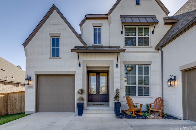 view of front facade featuring french doors and a garage