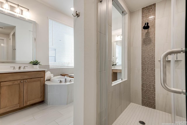 bathroom featuring tile patterned flooring, vanity, a shower with door, and a healthy amount of sunlight