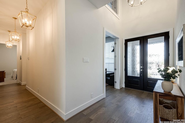 entryway featuring a notable chandelier, dark hardwood / wood-style floors, and french doors