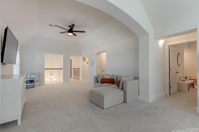 carpeted living room with ceiling fan and lofted ceiling