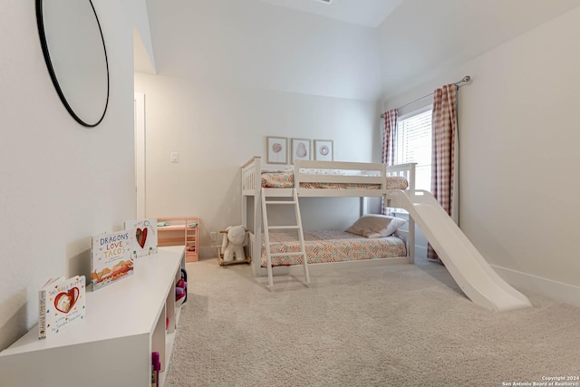 bedroom featuring light carpet and lofted ceiling