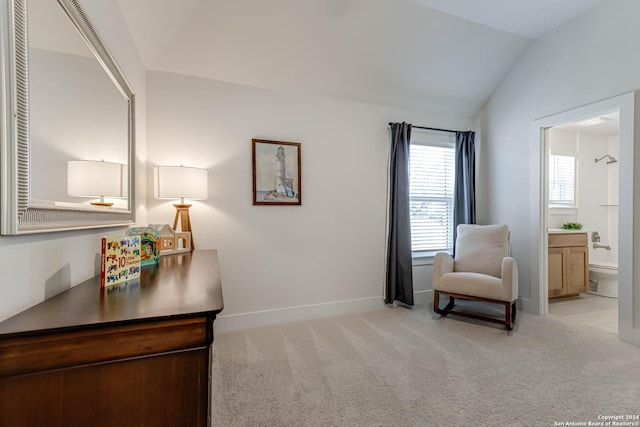 living area with light colored carpet and lofted ceiling