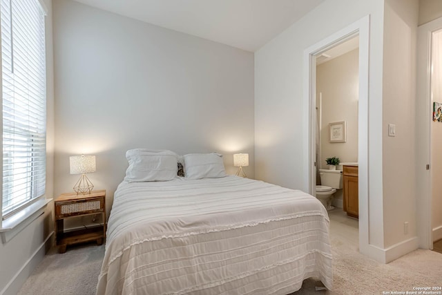 carpeted bedroom with ensuite bath