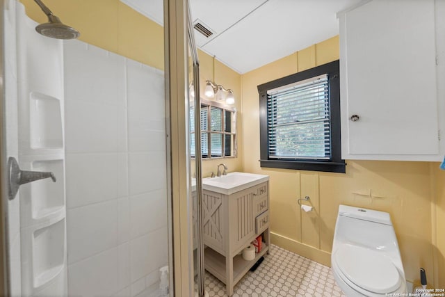 bathroom featuring a shower, vanity, and toilet