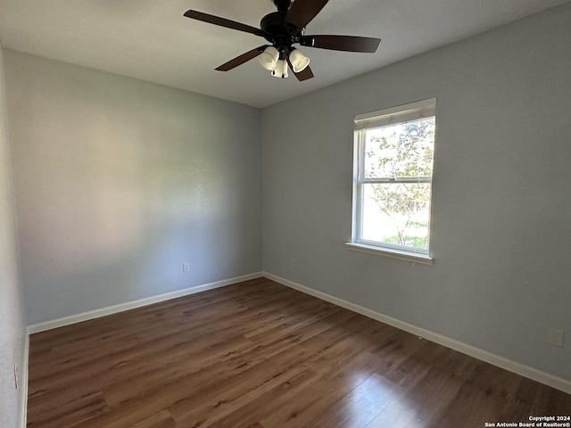 spare room featuring ceiling fan and dark hardwood / wood-style flooring