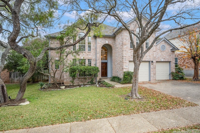 view of front facade with a garage and a front lawn