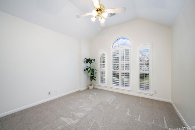 empty room featuring light carpet, ceiling fan, and lofted ceiling