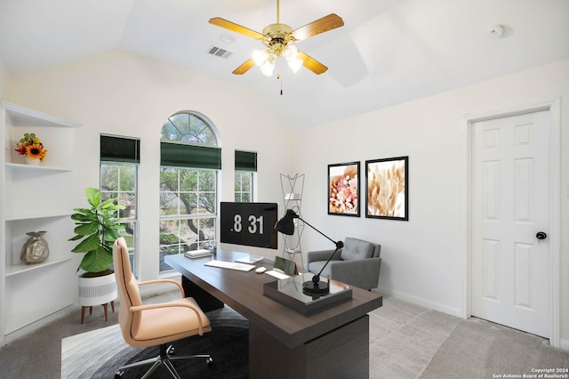 carpeted office space with ceiling fan and lofted ceiling