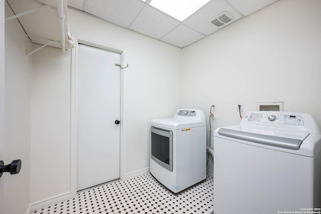 clothes washing area with washer and clothes dryer