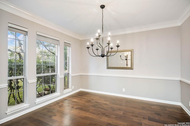 unfurnished dining area featuring crown molding, dark hardwood / wood-style flooring, and a chandelier