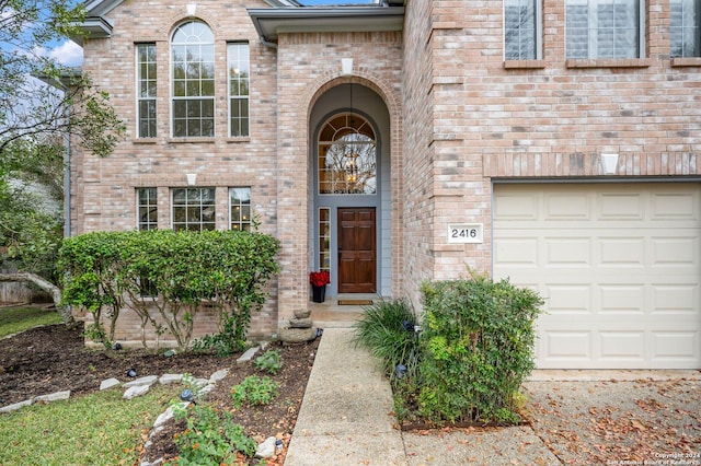 view of exterior entry with a garage