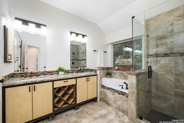 bathroom featuring vanity, lofted ceiling, and shower with separate bathtub