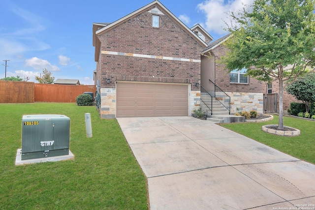 view of property featuring a garage and a front lawn