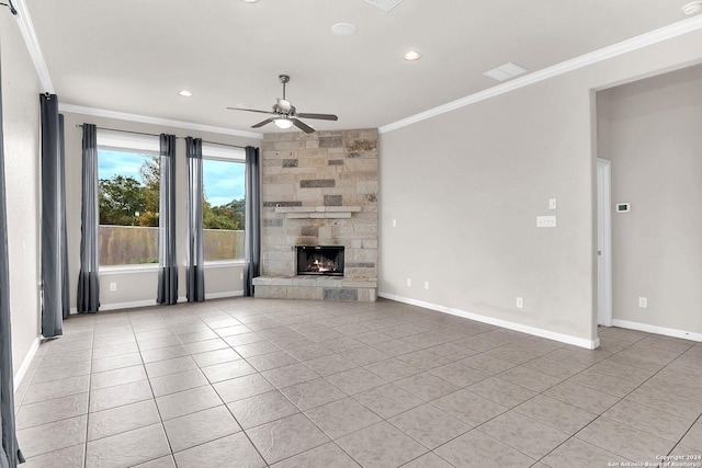 unfurnished living room featuring ceiling fan, light tile patterned flooring, a stone fireplace, and ornamental molding