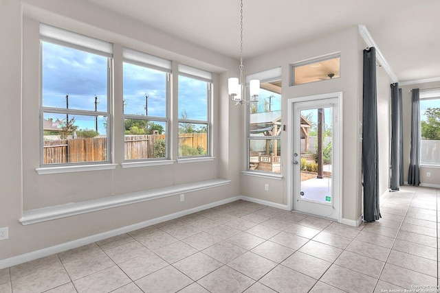 doorway with light tile patterned floors and a notable chandelier