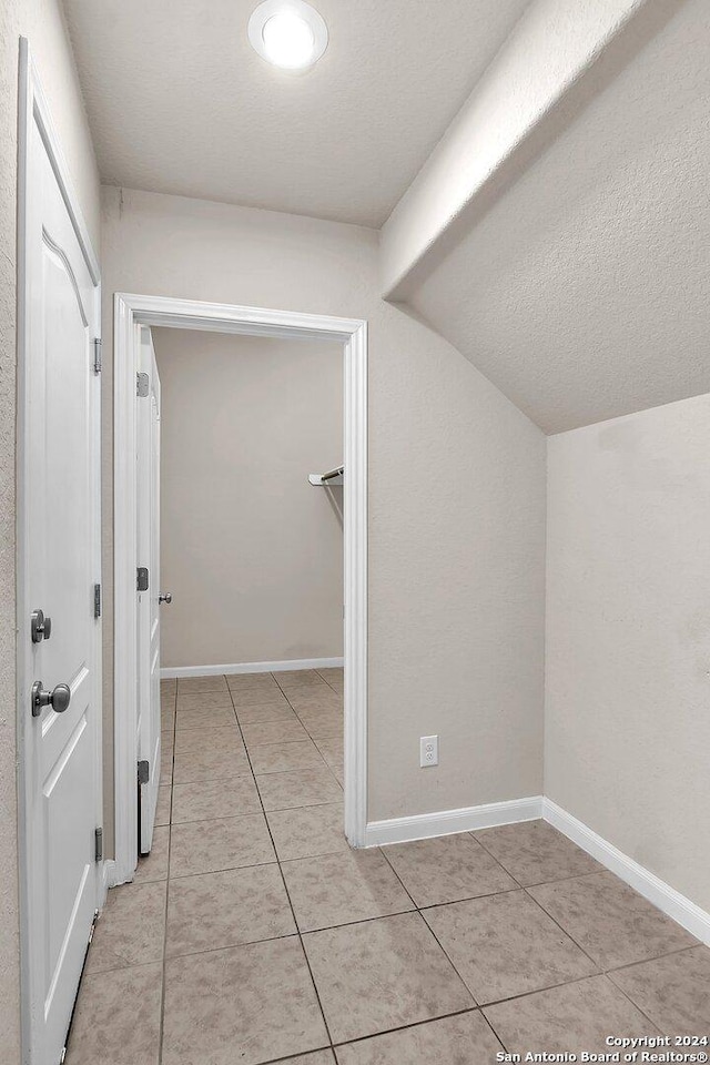 interior space featuring light tile patterned floors and a textured ceiling