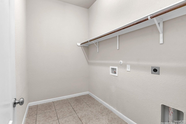 clothes washing area featuring gas dryer hookup, light tile patterned floors, washer hookup, and hookup for an electric dryer