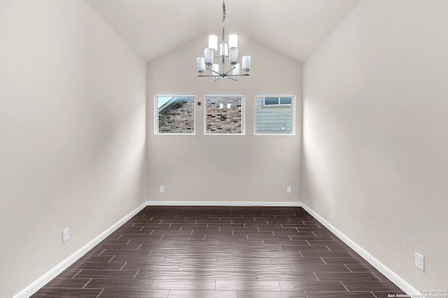 spare room with a chandelier and lofted ceiling