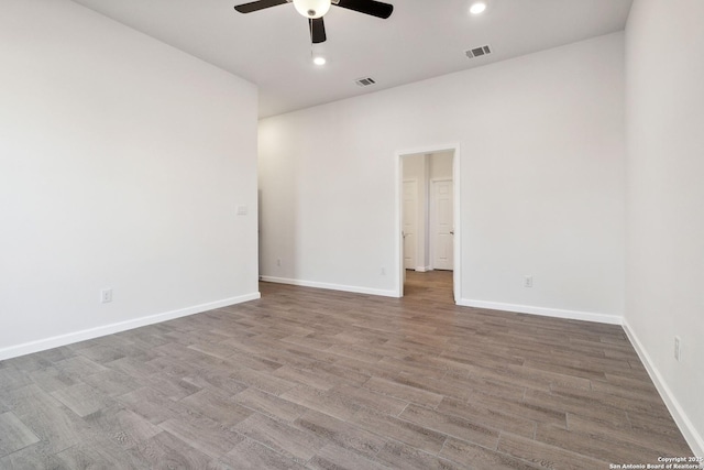 empty room with hardwood / wood-style floors and ceiling fan