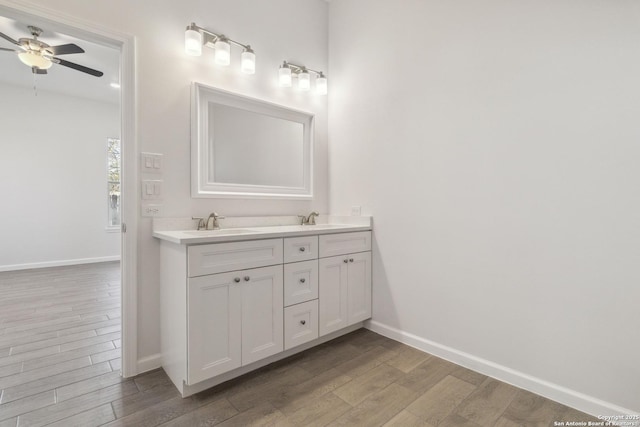 bathroom featuring wood-type flooring, vanity, and ceiling fan