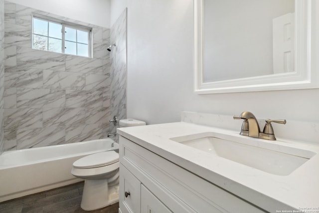 full bathroom featuring vanity, toilet, wood-type flooring, and tiled shower / bath