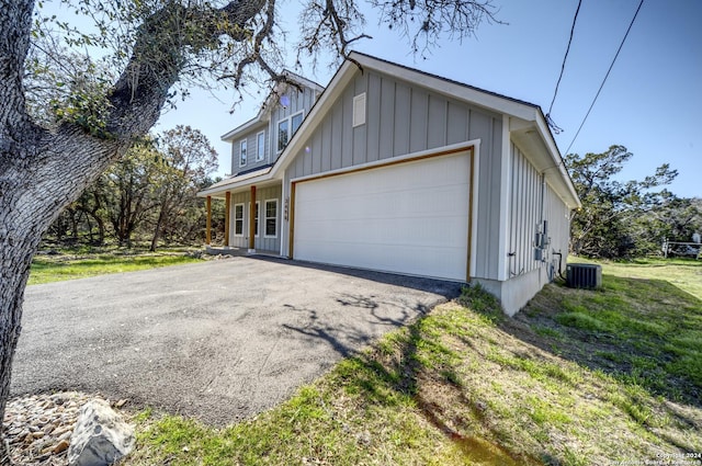 view of property exterior featuring a garage and central air condition unit