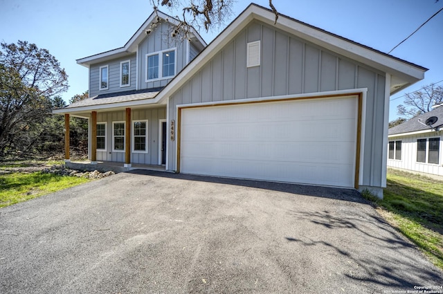 view of front of home featuring covered porch and a garage