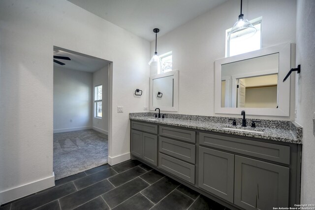 bathroom with tile patterned flooring, ceiling fan, and vanity