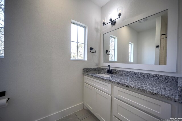 bathroom with tile patterned floors and vanity