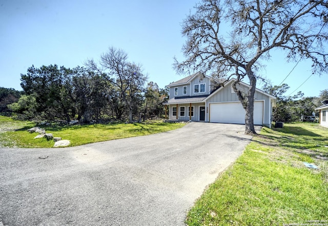 view of front of house featuring a garage and a front lawn