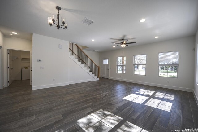 unfurnished living room featuring dark hardwood / wood-style flooring, ceiling fan with notable chandelier, and washer / dryer