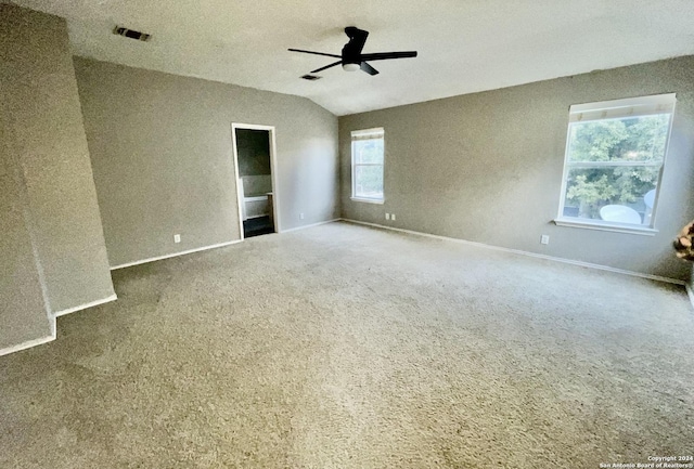 carpeted empty room with ceiling fan and lofted ceiling