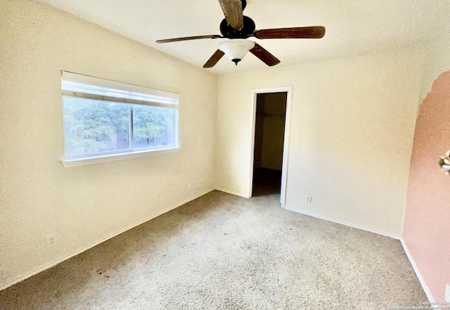 carpeted empty room with ceiling fan