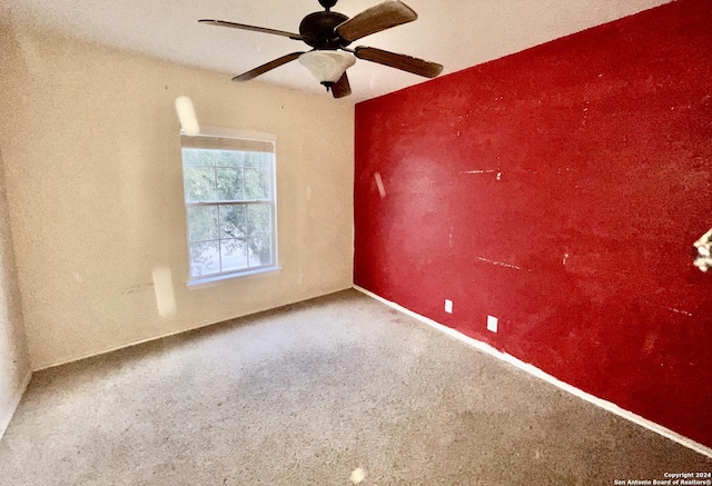 empty room with ceiling fan and carpet floors