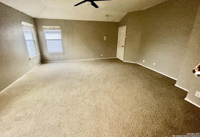 empty room featuring carpet floors and ceiling fan