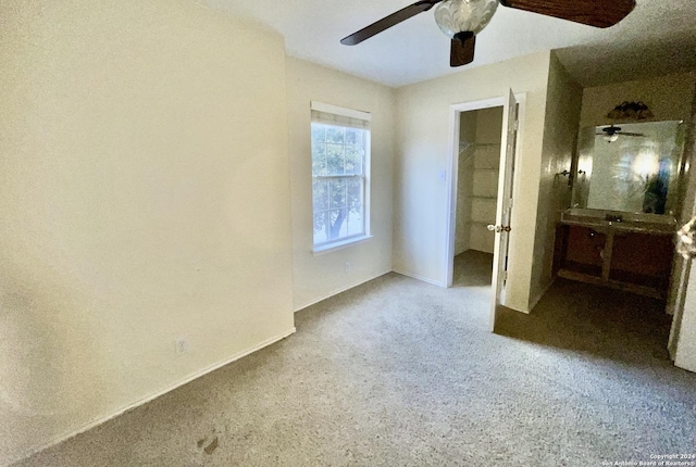 unfurnished bedroom with ceiling fan and carpet floors