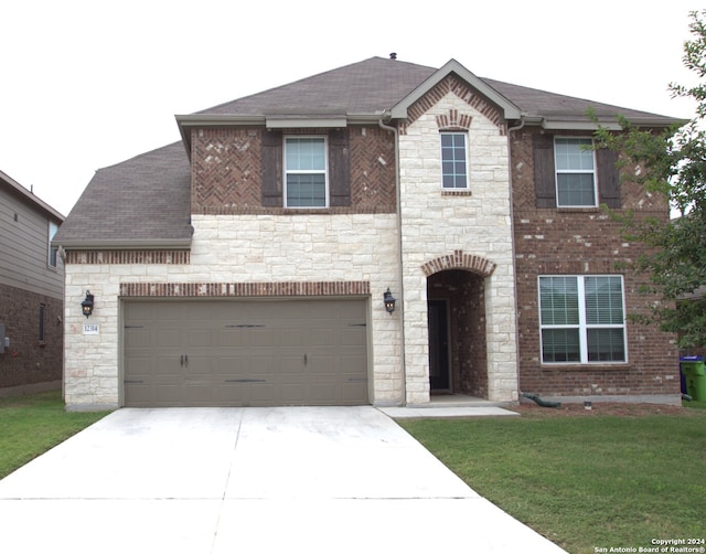 view of front of home featuring a front yard and a garage