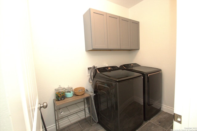 laundry room featuring cabinets and washing machine and clothes dryer