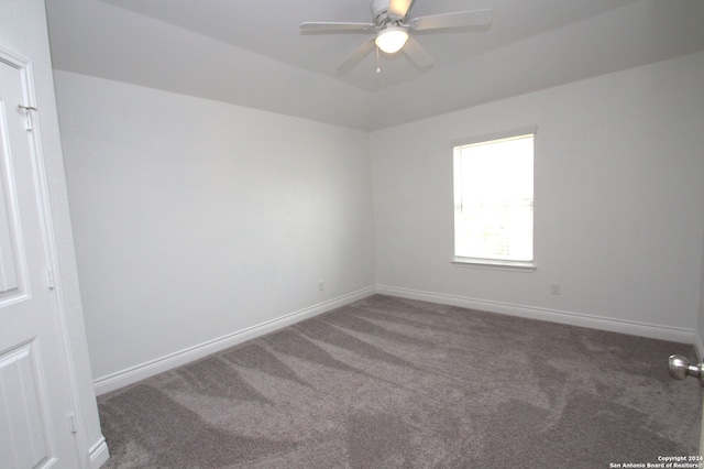 carpeted spare room with ceiling fan