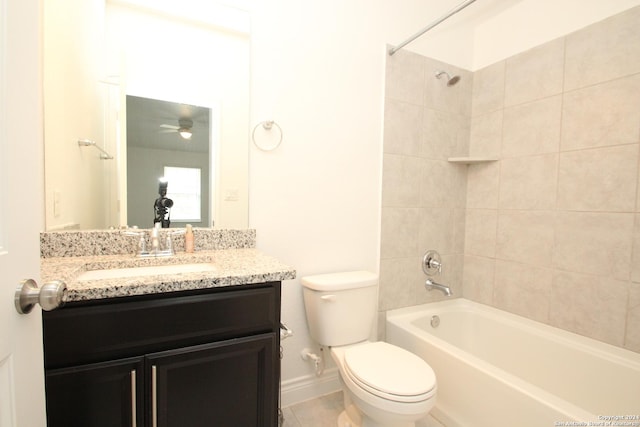 full bathroom with vanity, toilet, tiled shower / bath, and ceiling fan