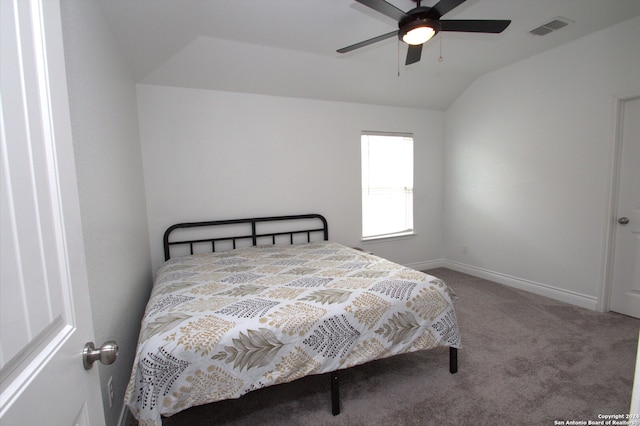 bedroom with ceiling fan, carpet floors, and vaulted ceiling