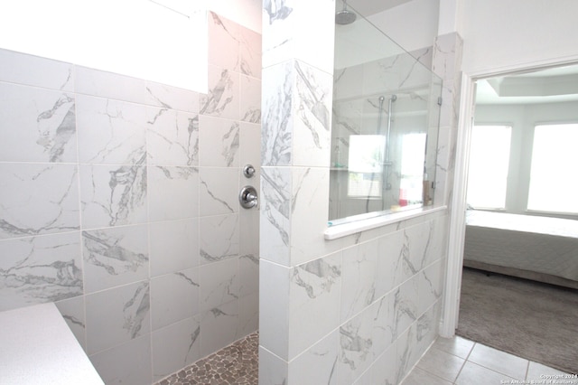 bathroom featuring a tile shower and tile patterned floors