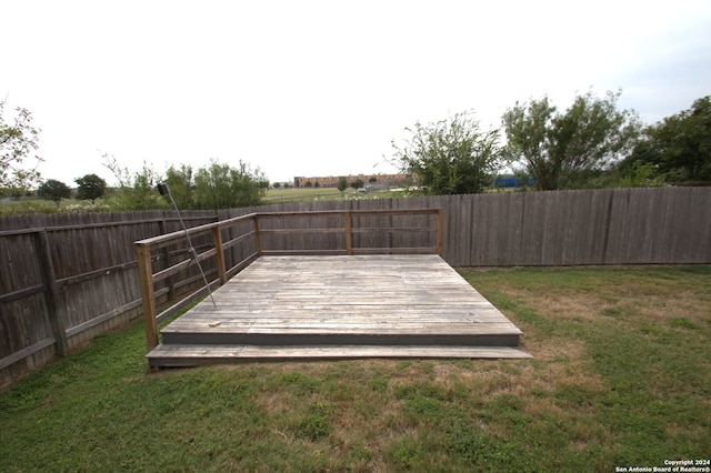 wooden deck featuring a yard