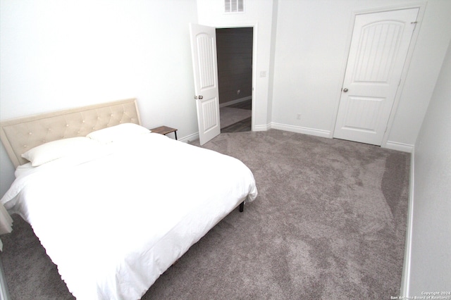 bedroom with dark colored carpet