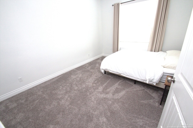 unfurnished bedroom featuring dark carpet